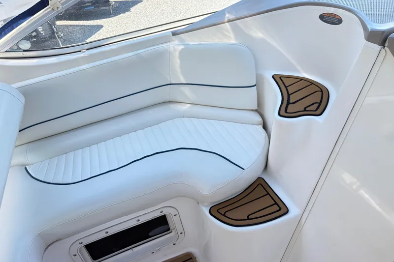Slide: The Image of 2003 Bayliner 285 Ciera boat interior with white seating and brown step accents. - 13