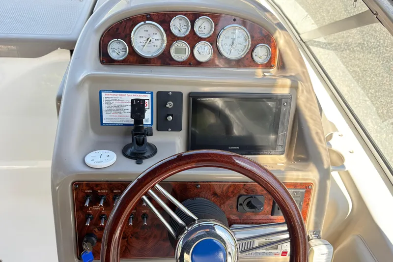 Slide: The Image of Dashboard of a 2003 Bayliner 285 Ciera boat with gauges and controls. - 15