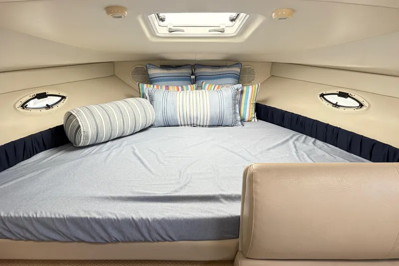 Slide: The Image of Interior cabin of 2003 Bayliner 285 Ciera with cozy bedding and porthole windows. - 20