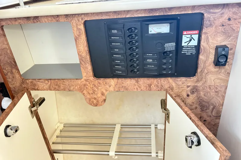 Slide: The Image of Electrical panel and storage area inside a 2003 Bayliner 285 Ciera boat. - 23