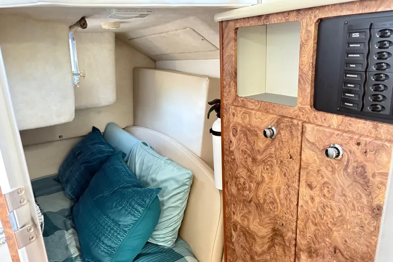 Slide: The Image of Interior cabin of 2003 Bayliner 285 Ciera with wood paneling and cozy bedding. - 25