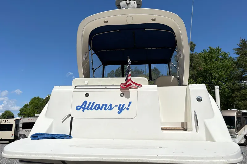 Slide: The Image of 2003 Bayliner 285 Ciera boat with "Allons-y!" text and American flag. - 5