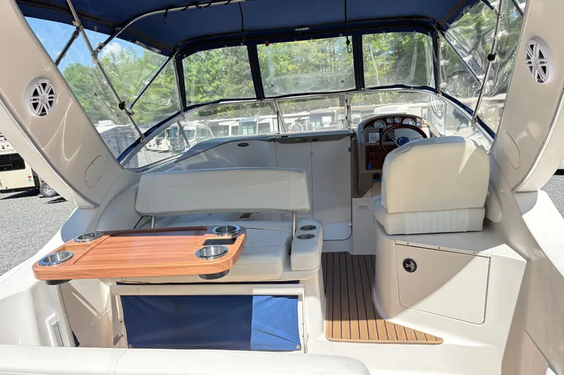 Slide: The Image of 2003 Bayliner 285 Ciera boat interior with seating, table, and steering area. - 9