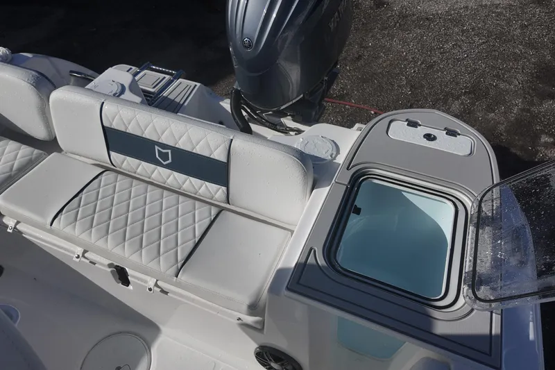 Slide: The Image of 2026 Sea Fox 228 Commander boat interior with cushioned seating and storage compartment. - 11