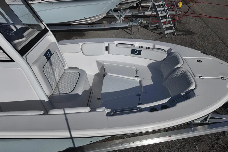 Slide: The Image of 2026 Sea Fox 228 Commander boat interior with cushioned seating and storage compartments. - 15