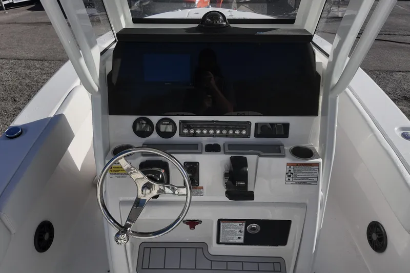 Slide: The Image of 2026 Sea Fox 228 Commander boat dashboard with steering wheel and control panel. - 5