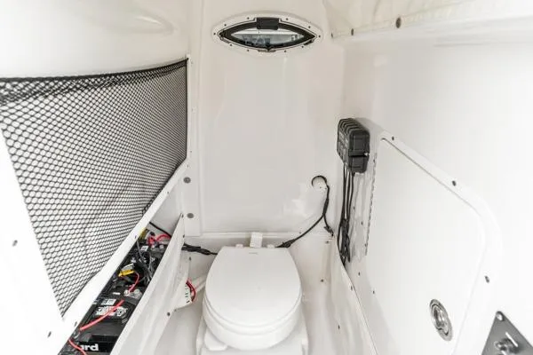 Slide: The Image of Interior of 2018 Sea Hunt Gamefish 27 boat with toilet and storage area. - 12