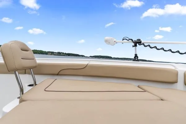 Slide: The Image of 2018 Sea Hunt Gamefish 27 boat interior with tan seating and clear blue sky. - 18