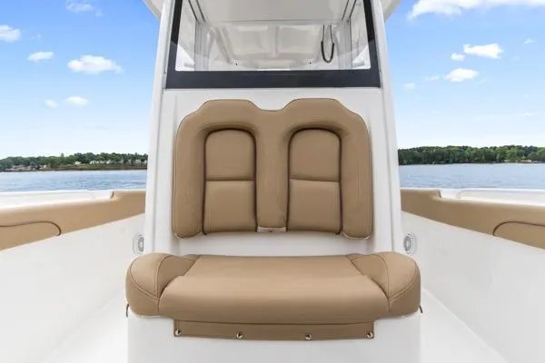 Slide: The Image of 2018 Sea Hunt Gamefish 27 boat interior with tan seating, calm water background. - 19