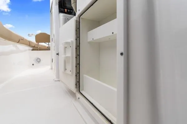 Slide: The Image of Open storage compartment on a 2018 Sea Hunt Gamefish 27 boat, white interior. - 21