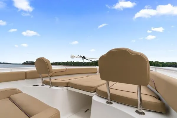 Slide: The Image of 2018 Sea Hunt Gamefish 27 boat with tan seating, clear sky, and water view. - 26