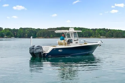 Slide: The Image of 2018 Sea Hunt Gamefish 27 boat on calm water with dual engines. - 3