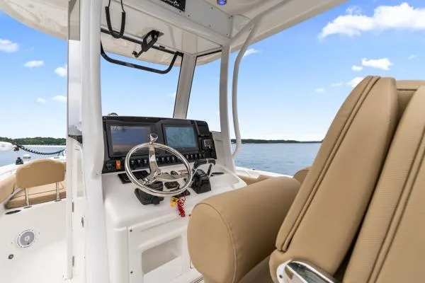 Slide: The Image of 2018 Sea Hunt Gamefish 27 boat interior with steering wheel and navigation system. - 36