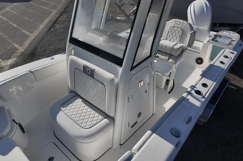 Slide: The Image of 2026 Sea Fox 248 Commander boat interior with cushioned seating and console. - 10