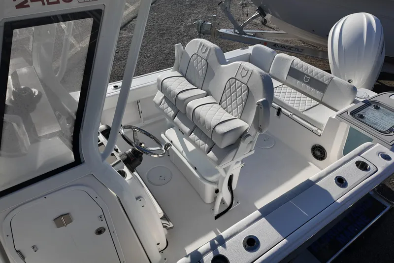 Slide: The Image of 2026 Sea Fox 248 Commander boat interior with white cushioned seating and steering wheel. - 12