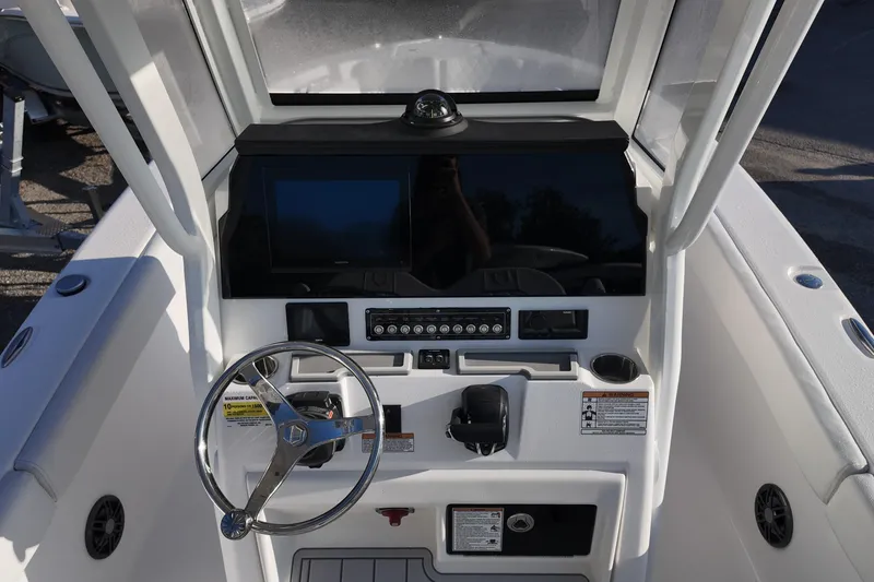 Slide: The Image of 2026 Sea Fox 248 Commander boat dashboard with steering wheel and control panel. - 6