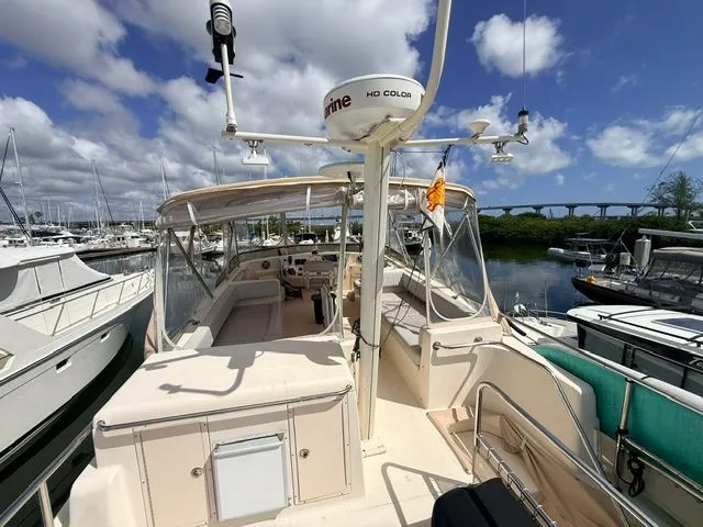 Slide: The Image of 2004 Mainship 400 Trawler docked in sunny marina. - 18