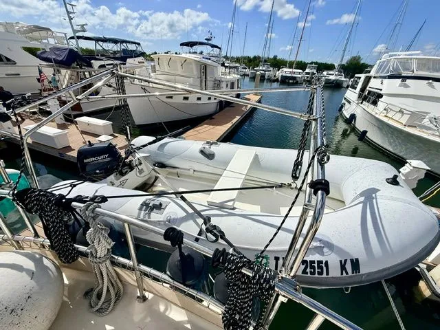 Slide: The Image of 2004 Mainship 400 Trawler docked with inflatable dinghy. - 5
