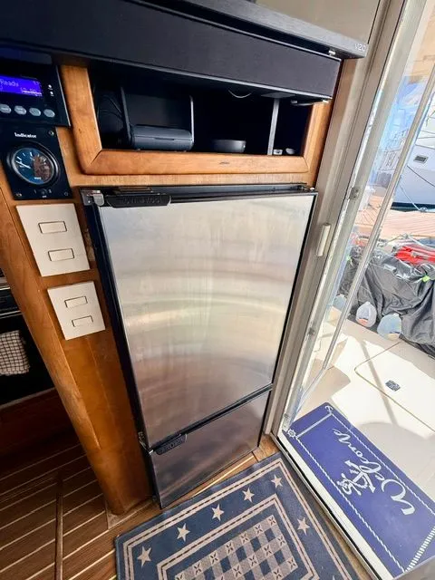 Slide: The Image of Mainship 400 Trawler 2004 kitchen area with stainless steel refrigerator. - 6