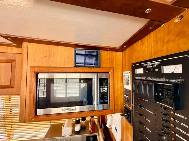 Slide: The Image of Interior of 2004 Mainship 400 Trawler with microwave and control panel. - 7