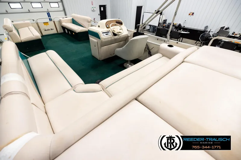 Slide: The Image of Interior of a 1998 Godfrey SW2423 boat with beige seating and green carpet. - 11