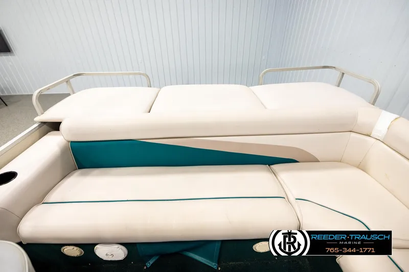 Slide: The Image of 1998 Godfrey SW2423 boat interior with teal and cream seating. - 15