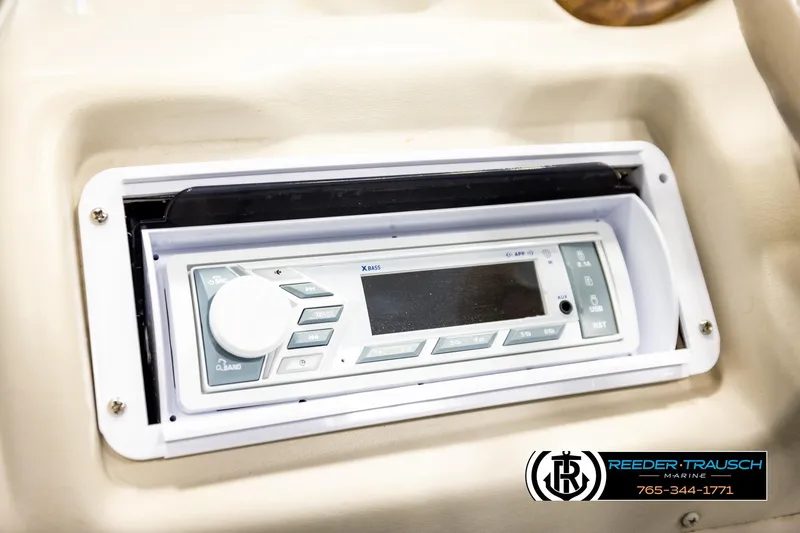 Slide: The Image of 1998 Godfrey SW2423 boat stereo system with control panel and display. - 25