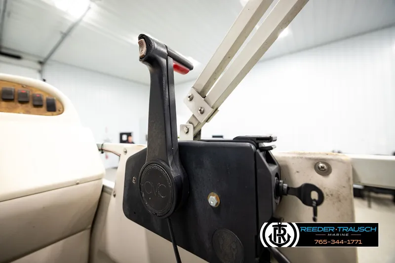 Slide: The Image of Close-up of a 1998 Godfrey SW2423 boat throttle control in a marine setting. - 28