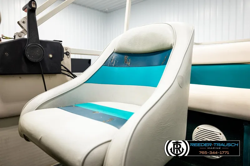 Slide: The Image of 1998 Godfrey SW2423 boat seat with teal and white upholstery, featuring Reeder-Trausch Marine branding. - 29