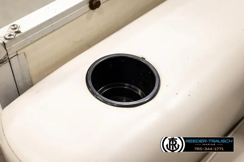 Slide: The Image of Cup holder on a 1998 Godfrey SW2423 boat, featuring beige upholstery. - 33