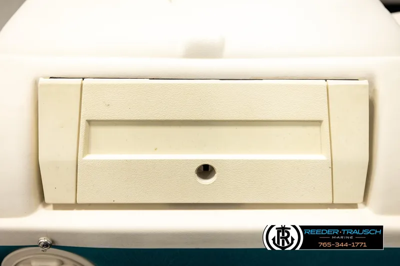 Slide: The Image of Close-up of a 1998 Godfrey SW2423 boat compartment with Reeder-Trausch Marine logo. - 34