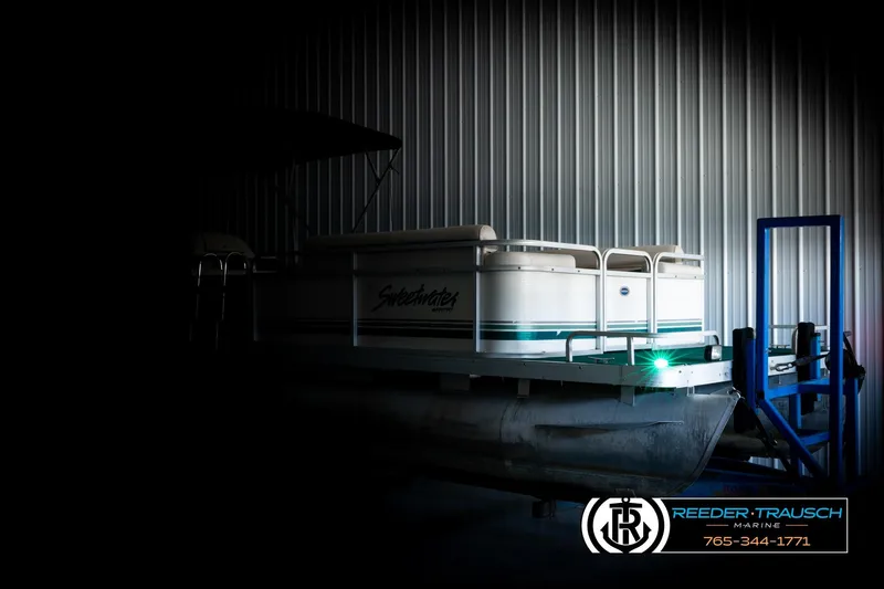 Slide: The Image of 1998 Godfrey SW2423 pontoon boat in storage at Reeder-Trausch Marine facility. - 4