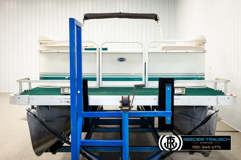 Slide: The Image of 1998 Godfrey SW2423 pontoon boat on trailer in indoor storage facility. - 8
