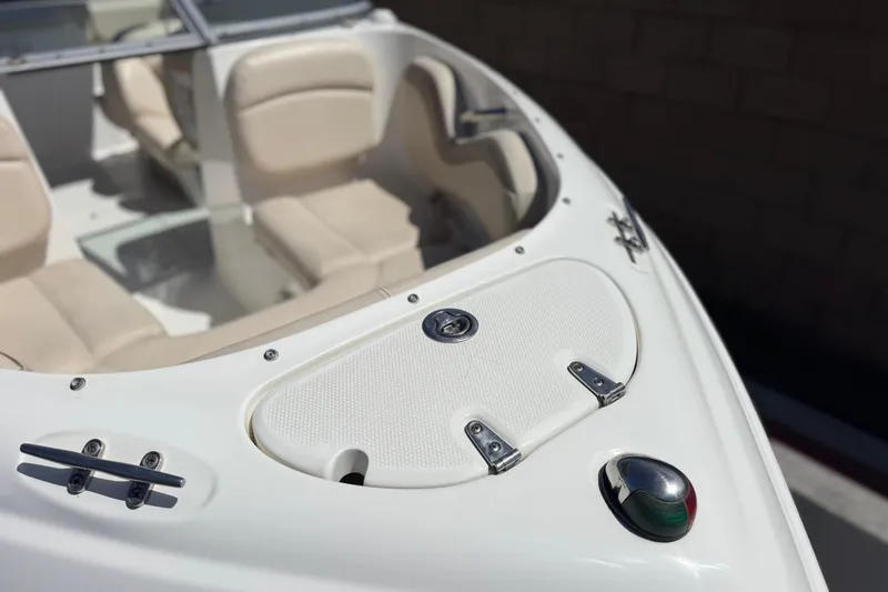 Slide: The Image of 2006 Chaparral 190 SSi boat interior with beige seating and deck details. - 10