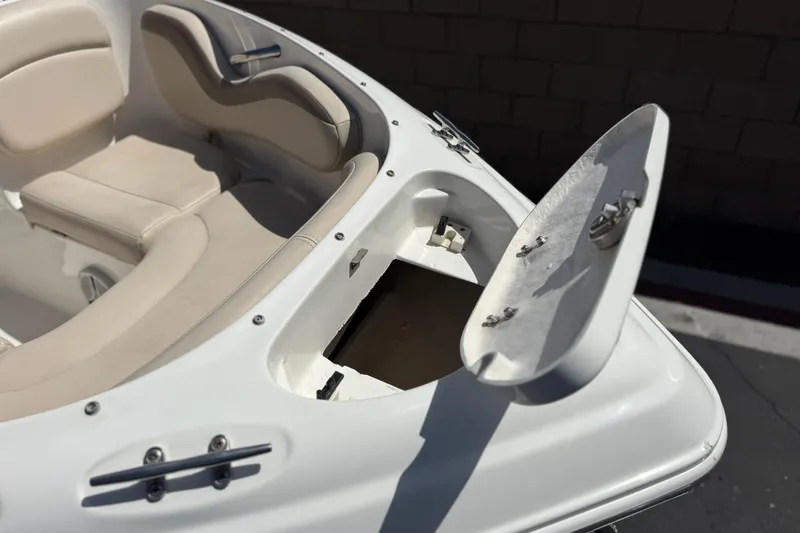 Slide: The Image of 2006 Chaparral 190 SSi boat interior with open storage compartment and beige seating. - 11