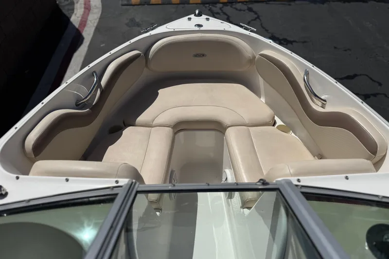 Slide: The Image of 2006 Chaparral 190 SSi boat interior with beige seating and stainless steel handles. - 12