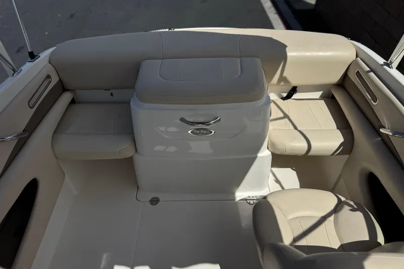 Slide: The Image of 2006 Chaparral 190 SSi boat interior with beige seating and storage compartment. - 16