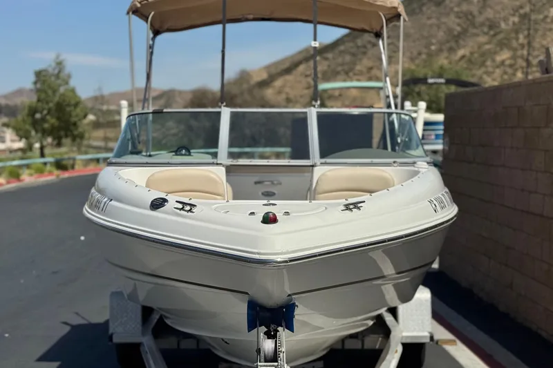 Slide: The Image of 2006 Chaparral 190 SSi boat on trailer, parked outdoors with scenic background. - 2