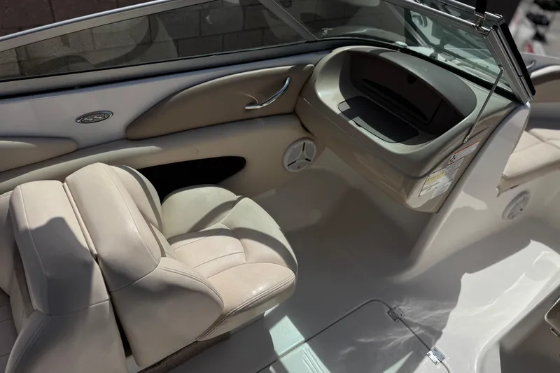 Slide: The Image of Interior of a 2006 Chaparral 190 SSi boat with beige seating and dashboard. - 20