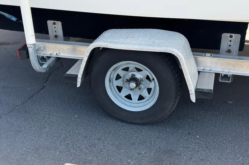 Slide: The Image of Trailer wheel of a 2006 Chaparral 190 SSi boat on pavement. - 26