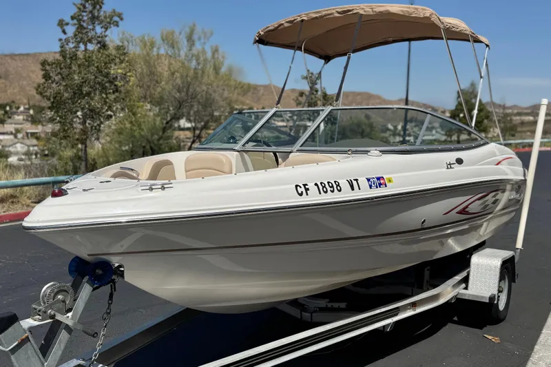 Slide: The Image of 2006 Chaparral 190 SSi boat on trailer with canopy, parked outdoors. - 3