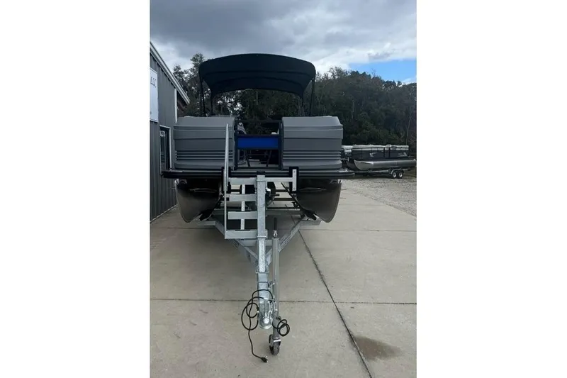 The Image of 2026 SunChaser Lucerne 20 LR DH pontoon boat on trailer, outdoor setting. - 1