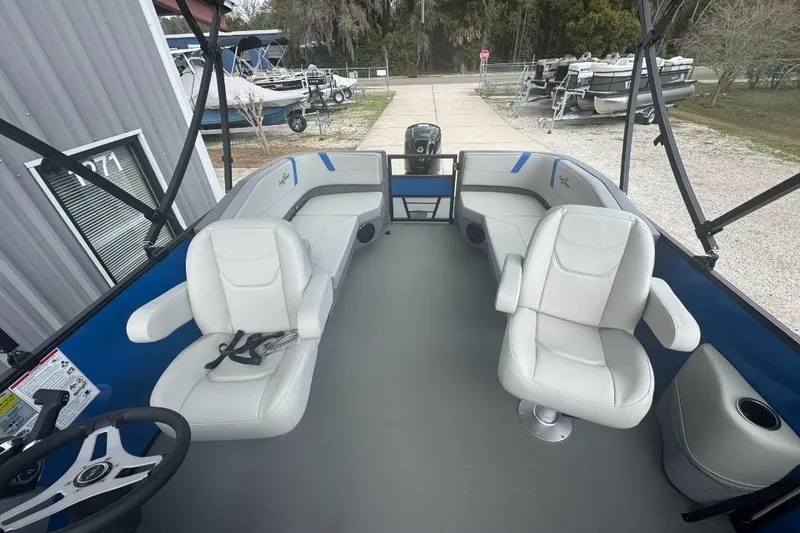 Slide: The Image of 2026 SunChaser Lucerne 20 LR DH pontoon boat interior with white seating and steering wheel. - 4