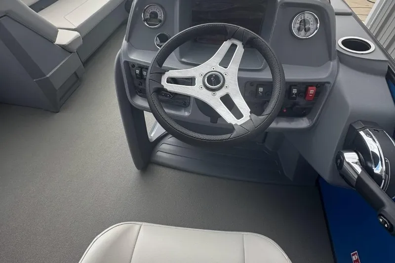 Slide: The Image of 2026 SunChaser Lucerne 20 LR DH boat interior with steering wheel and dashboard controls. - 6