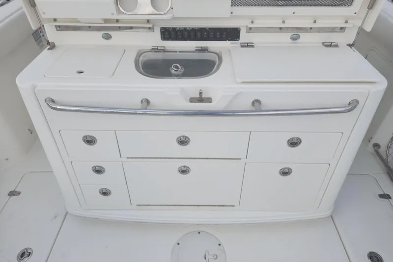 Slide: The Image of 2014 Boston Whaler 350 Outrage boat galley with sink and storage drawers. - 16