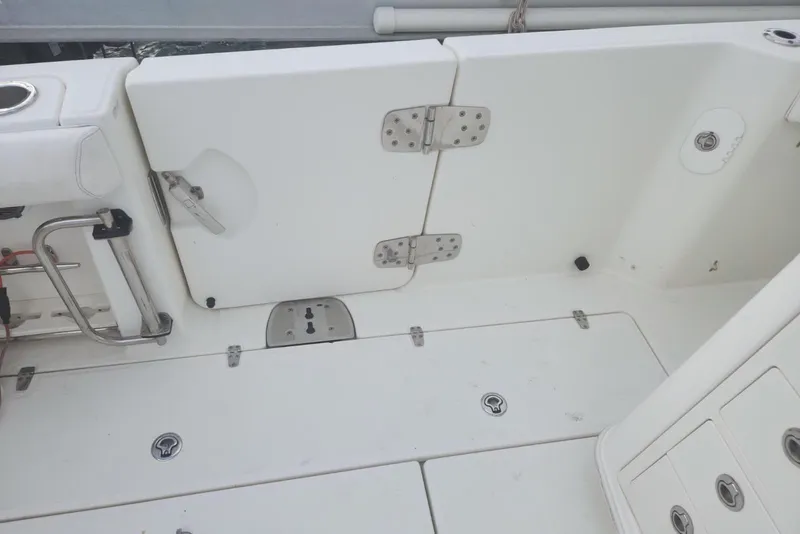 Slide: The Image of 2014 Boston Whaler 350 Outrage deck with storage compartments and stainless steel fittings. - 17