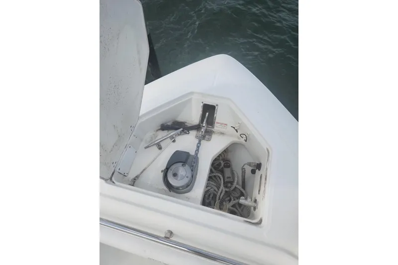 Slide: The Image of Open anchor compartment on 2014 Boston Whaler 350 Outrage boat, showing ropes and equipment. - 22