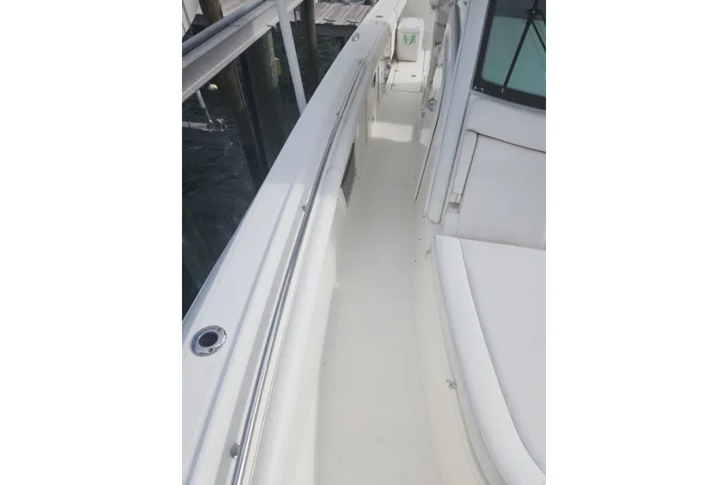 Slide: The Image of 2014 Boston Whaler 350 Outrage boat deck with white seating and sleek design. - 25