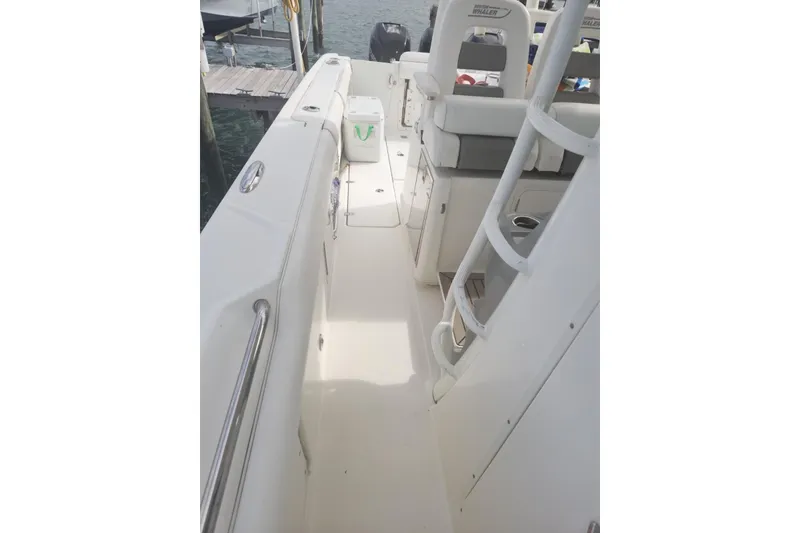 Slide: The Image of 2014 Boston Whaler 350 Outrage boat interior with seating and storage compartments. - 26