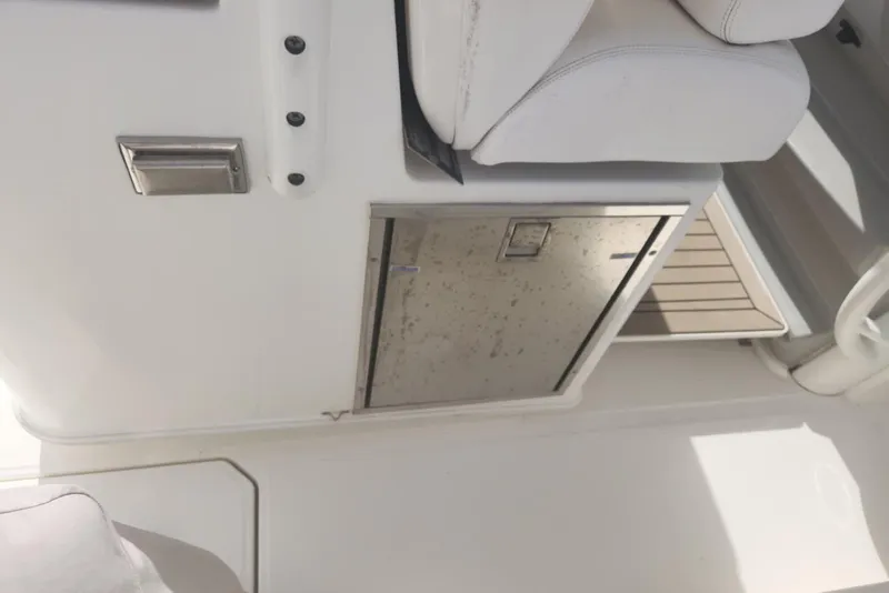 Slide: The Image of 2014 Boston Whaler 350 Outrage interior with seating and storage compartment. - 27